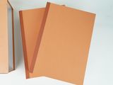 three pieces of brown paper sitting next to each other on a white surface