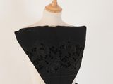 a close up of a black dress on a mannequin mannequin