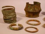 several pieces of old metal are sitting on a white surface