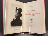 an open book with a picture of a man in a hat on it