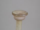 a small glass vase with a ring on top of it