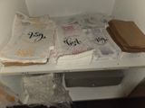 many napkins on a white shelf in a room