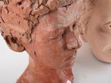 two clay heads of a woman and a head of a man