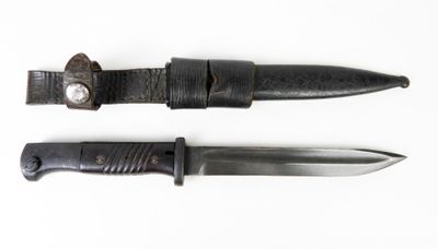 pair of knives on a white surface with a white background