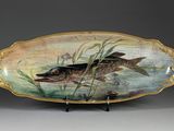 une image représentant une assiette décorative sur laquelle est peint un poisson