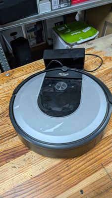 an image of a robotic vacuum cleaner sitting on a wooden table