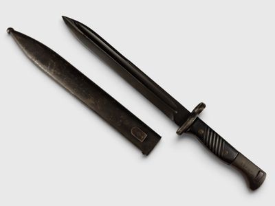 pair of black knifes on a white surface with a white background