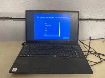 a laptop that is sitting on a table with a blue screen