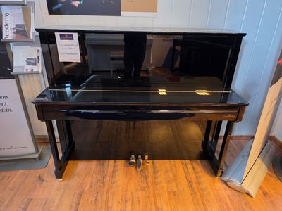 a piano that is sitting on the floor in a room