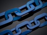 two blue chains on a black surface with a black background