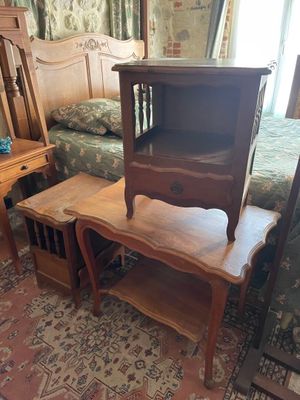 a bed and a table in a room with a bed in the background