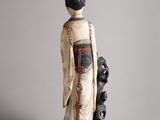 figurine of a woman and a cat on a grey background