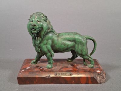 bronze statue of a lion on a marble base on a gray background