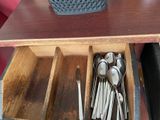 spoons and spoon rest in a wooden box on a table