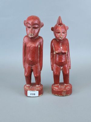 paire de figurines rouges sculptées représentant un singe et un homme-singe