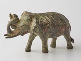 figurine of an elephant on a white surface with a white background