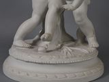 a statue of a boy and a girl playing with a ball