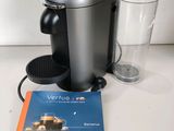 a coffee maker and a glass on a table