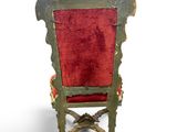 a red chair that is sitting on a white surface