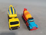 two toy trucks that are sitting next to each other