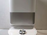 an image of a white air purifier sitting on top of a table