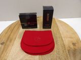 the red wallet is sitting on top of the wooden table