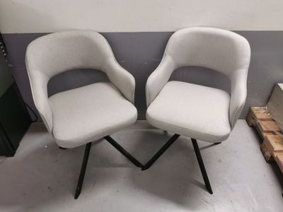 two chairs sitting next to each other in a room