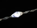 a close up of a bracelet with a blue glass bead
