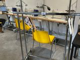 a yellow chair sitting in front of a work station