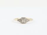 a yellow gold ring with a white diamond in the center