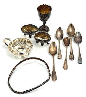 a lot of silver spoons and silverware on the table