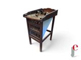 a small wooden table with a magazine rack on top of it