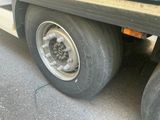 a flat tire on a flatbed truck parked on the street