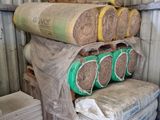 a stack of rolls of insulation sitting on top of pallets