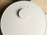 a white robot that is sitting on a wooden table