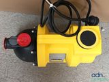 the yellow pump is sitting on the floor next to the wall