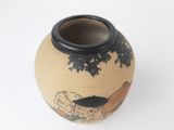 a small vase with a painting on it sitting on a table