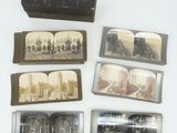 several old photos of buildings and a book on a table
