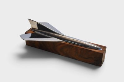 a knife that is sitting on top of a piece of wood