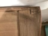 a bed with a wooden headboard and a blue pillow