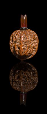 a wooden object that is sitting on a black surface
