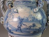 a large blue and white vase with a painting on it