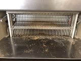 a dirty counter top in a kitchen with a metal shelf