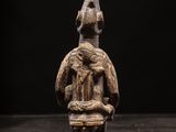 a wooden statue of a man with a hat on his head