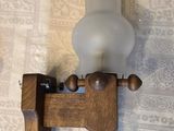 a candle that is on a wooden holder on a table