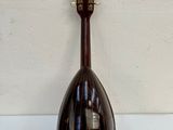 an image of a mandolin sitting on top of a white table