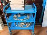 an image of a blue cart with a computer on top of it