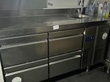 a large kitchen with a lot of stainless steel counter tops