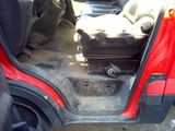 a red car with a suitcase in the back of it