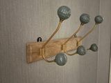 a picture of a wall mounted coat rack in a bathroom